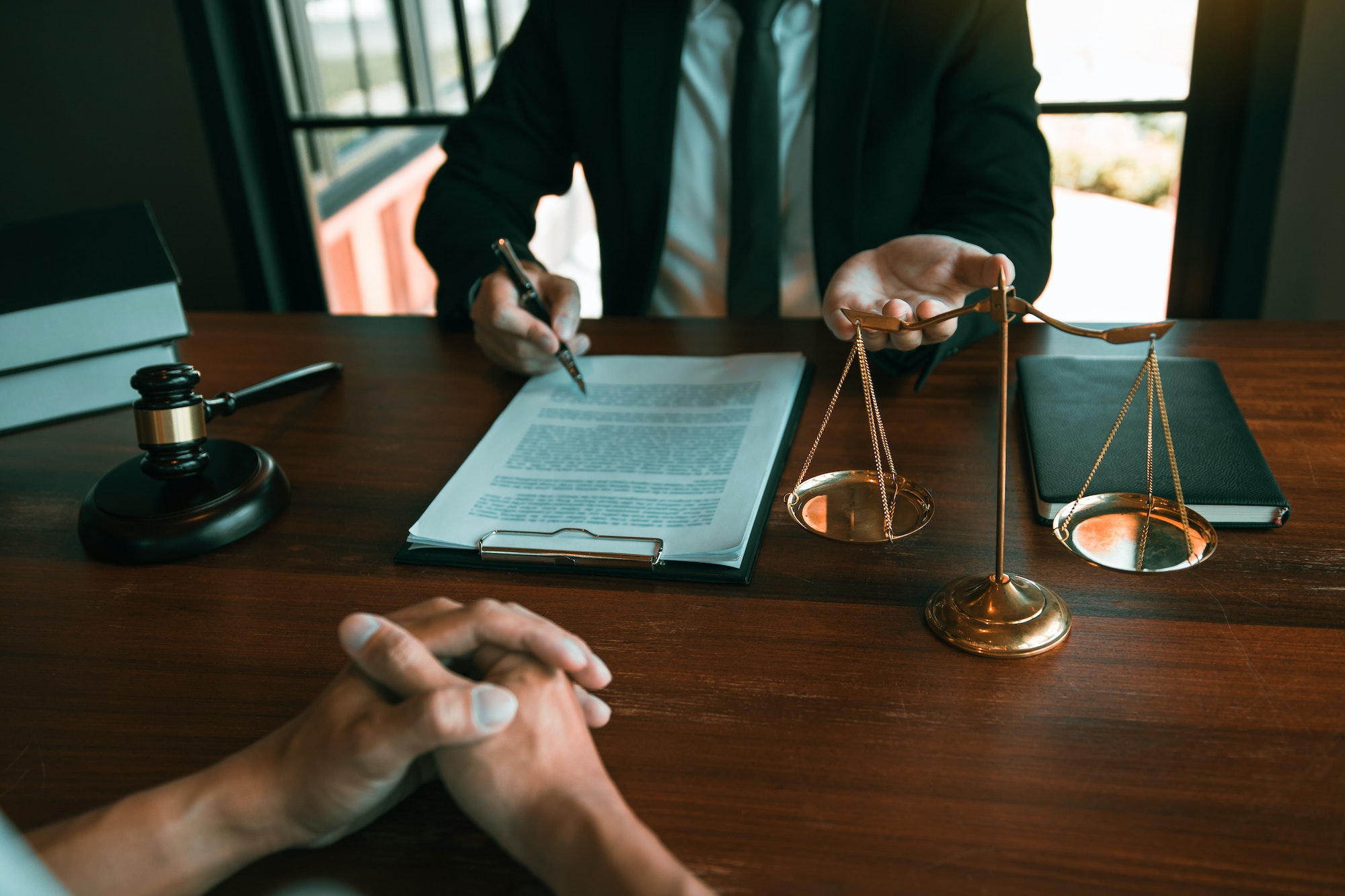 Lawyer is providing information about the client's trial at the lawyer office.